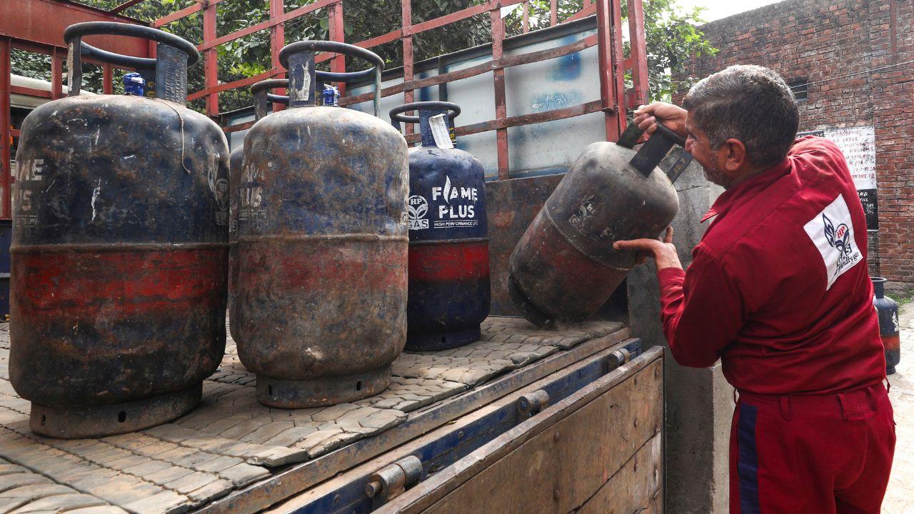 A worker loads LPG cylinders onto a truck, in Jammu depicting LPG shortage all over the nation