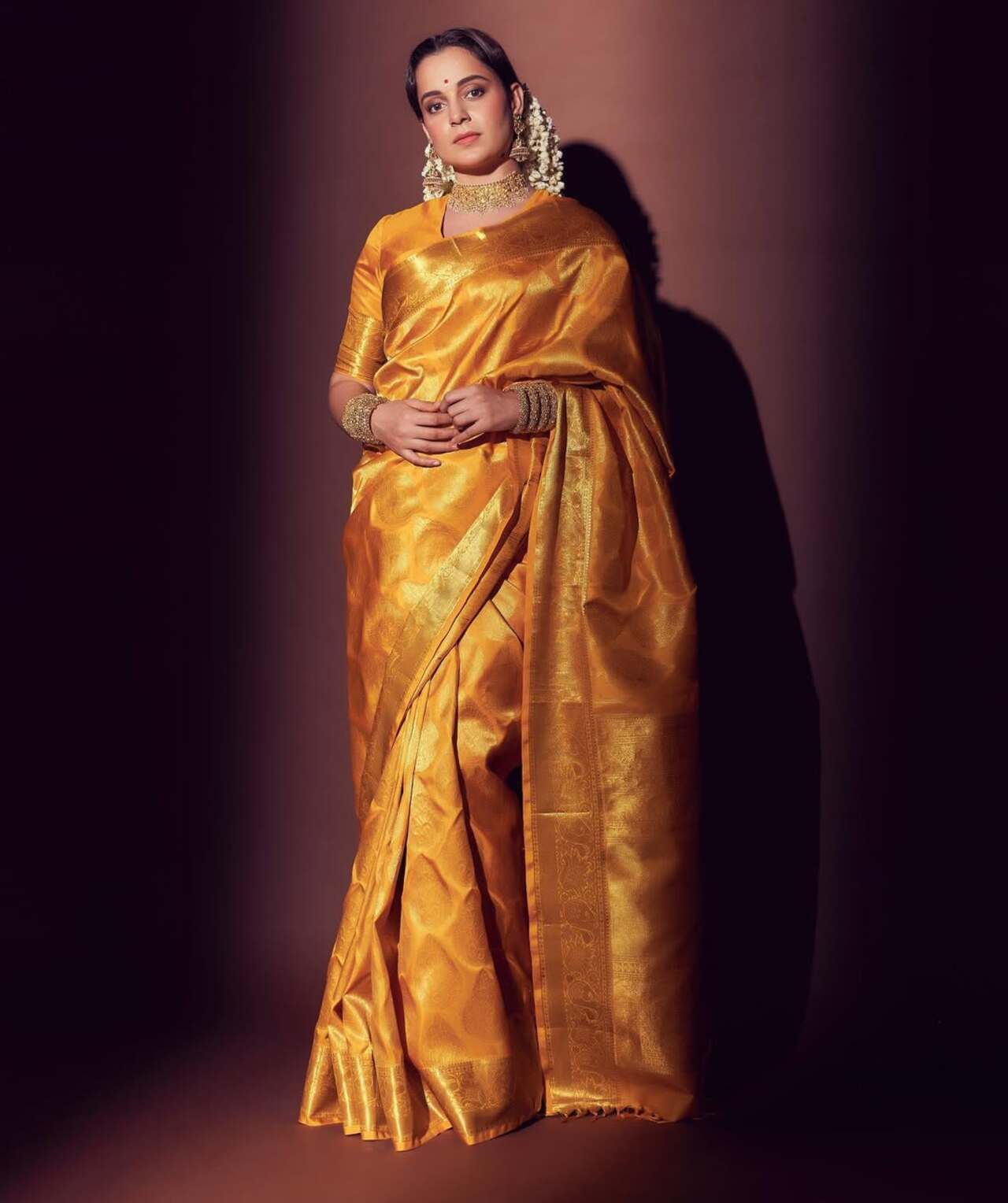 Kangana Ranaut stuns in a regal Paithani saree, making a perfect statement for Gudi Padwa. Dressed in a rich golden silk drape with intricate zari work, she pairs it with a matching blouse and traditional jewellery.