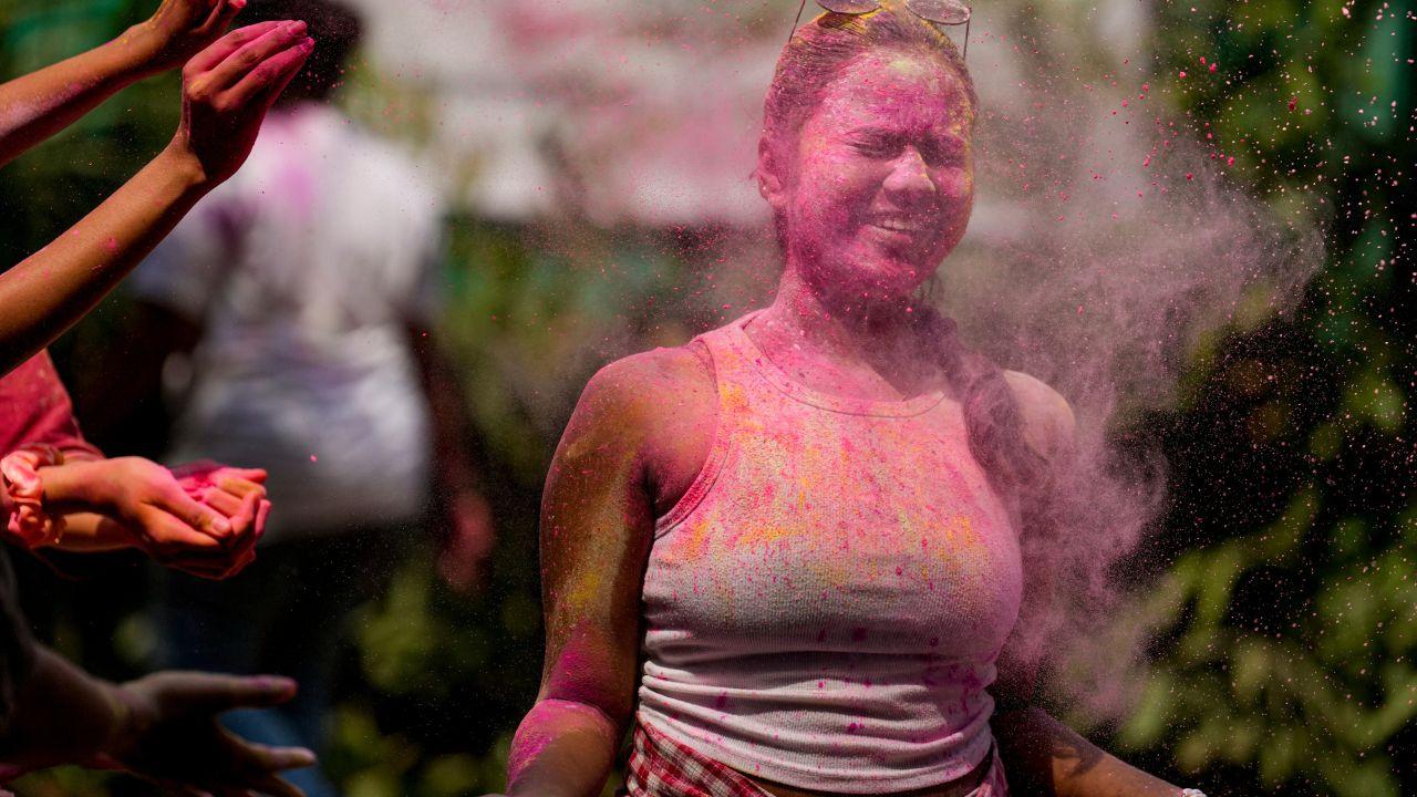 Clouds of colour rise above cheering crowds as Holi festivities sweep across the country