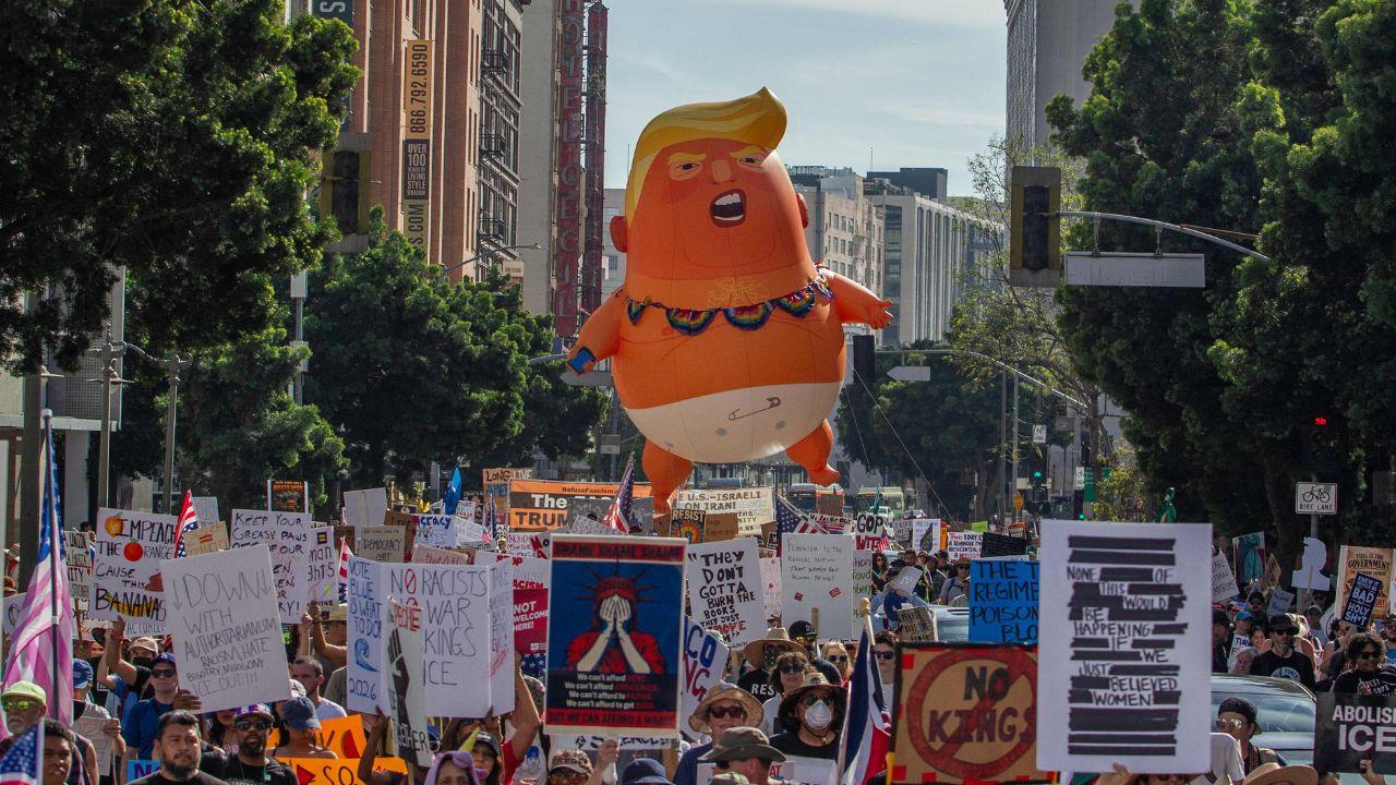 Families and activists carried signs, banners and a 20-foot helium-filled Trump balloon in a diaper, mocking him while amplifying the visual message of resistance