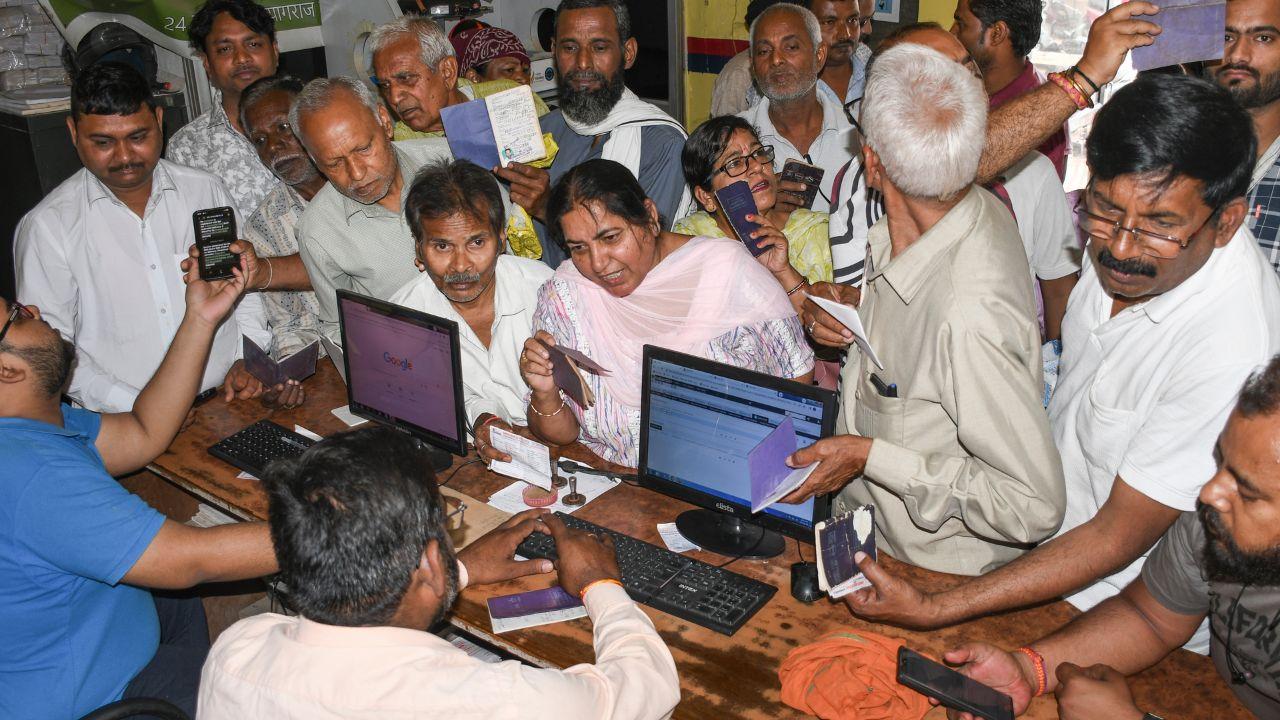 People gather to book LPG cylinders at an Indane gas agency, in Prayagraj, Uttar Pradesh. 
