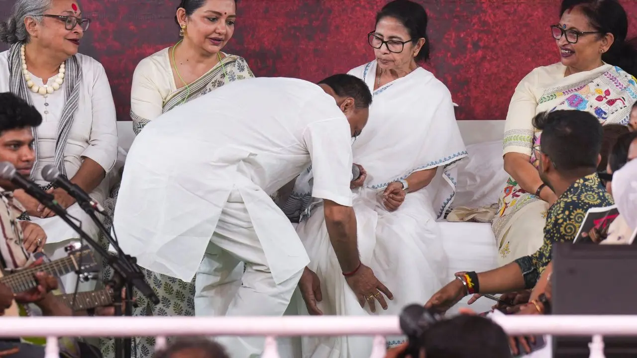 A Trinamool Congress leader seeks blessings from West Bengal Chief Minister Mamata Banerjee during a sit-in dharna on the fourth day of a protest against alleged arbitrary deletions from the post-SIR electoral rolls