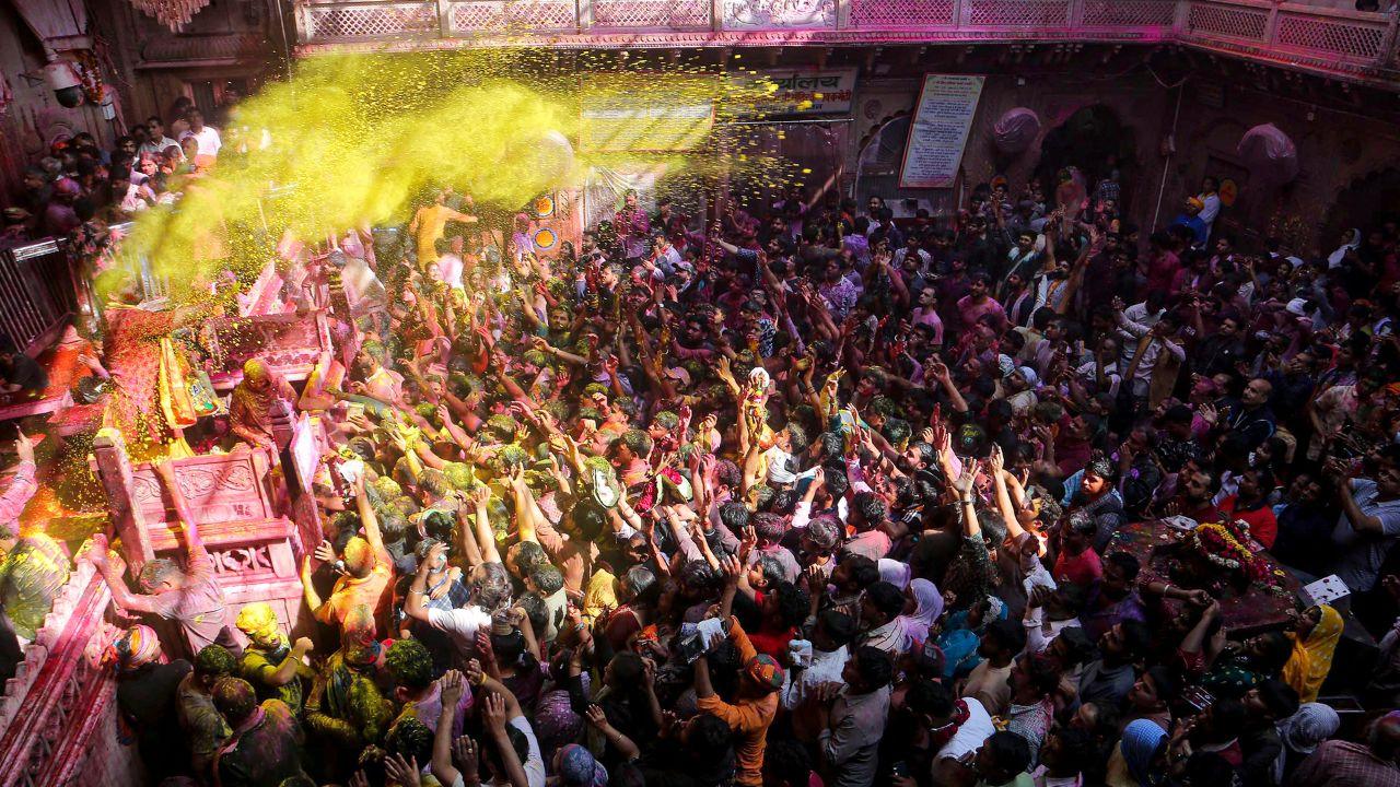 Clouds of gulal rise above the crowd while devotees sing, dance, and celebrate Holi with unmatched energy.