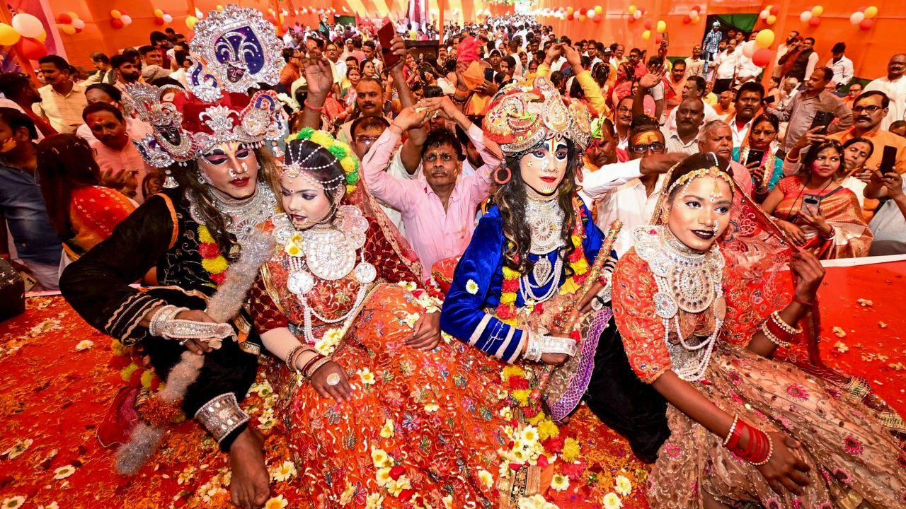  Artists dressed as Lord Krishna and Radha perform during a 'Holi Milan Samaroh' as part of the 'Holi' festival celebrations, in Patna. 