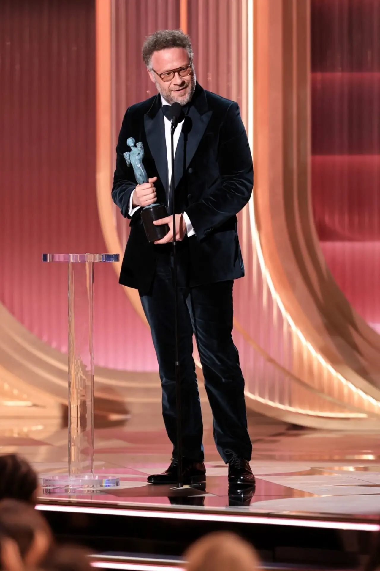 Seth Rogen wore a black tuxedo jacket with satin peak lapels paired with matching pants. He completed the look with crisp white dress shirt and a black bow tie.