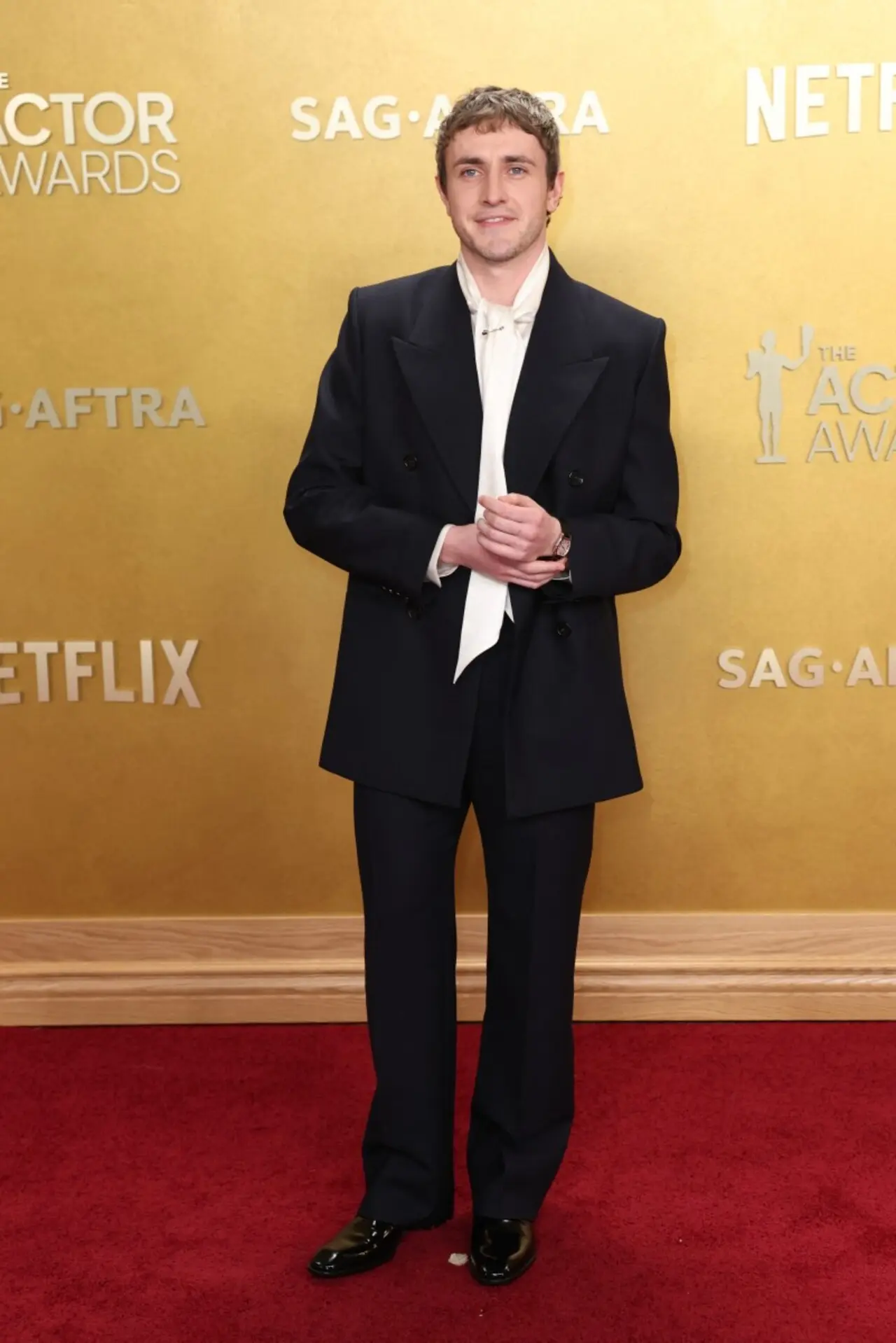 Paul Mescal gave a double-breasted suit a unique twist by pairing it with a white satin shirt featuring a wide, flowing collar tie.