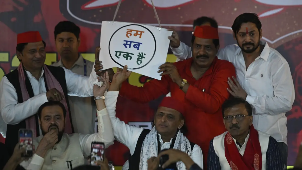 Party supporters display a unity placard at the event, as Yadav calls for peace and solidarity