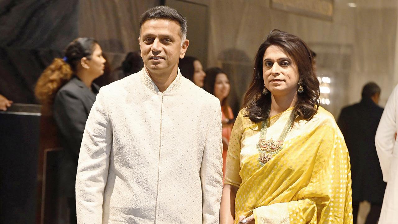 Cricket legend Rahul Dravid poses with wife Vijeta Pendharkar as they attend the wedding ceremony of Arjun Tendulkar