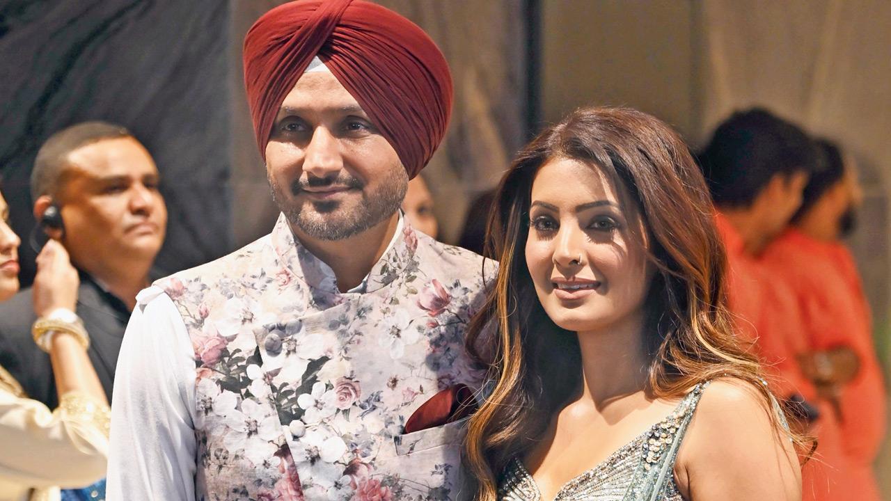 Former India spinner Harbhajan Singh arrives with wife Geeta Basra to attend the wedding festivities