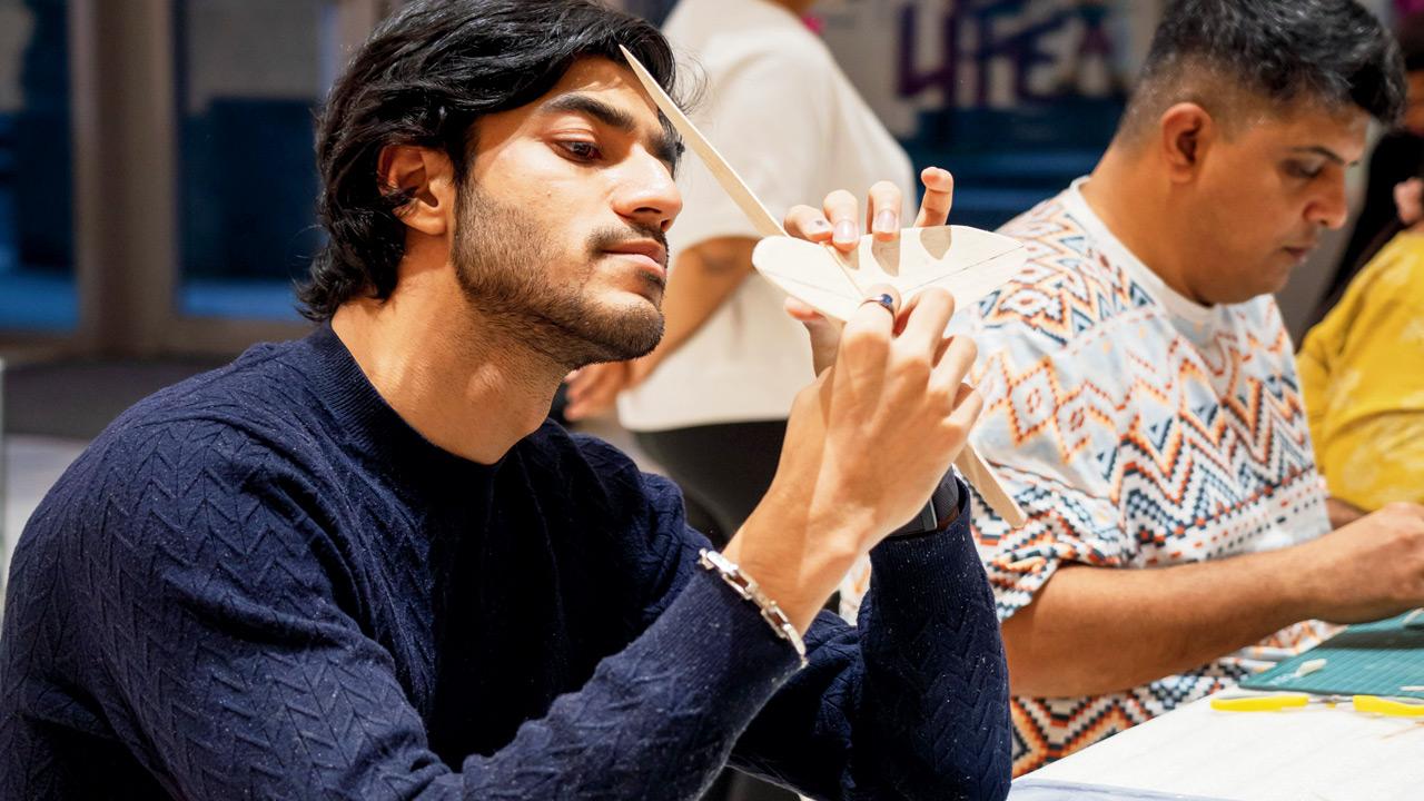 Participants work on their models at an earlier session