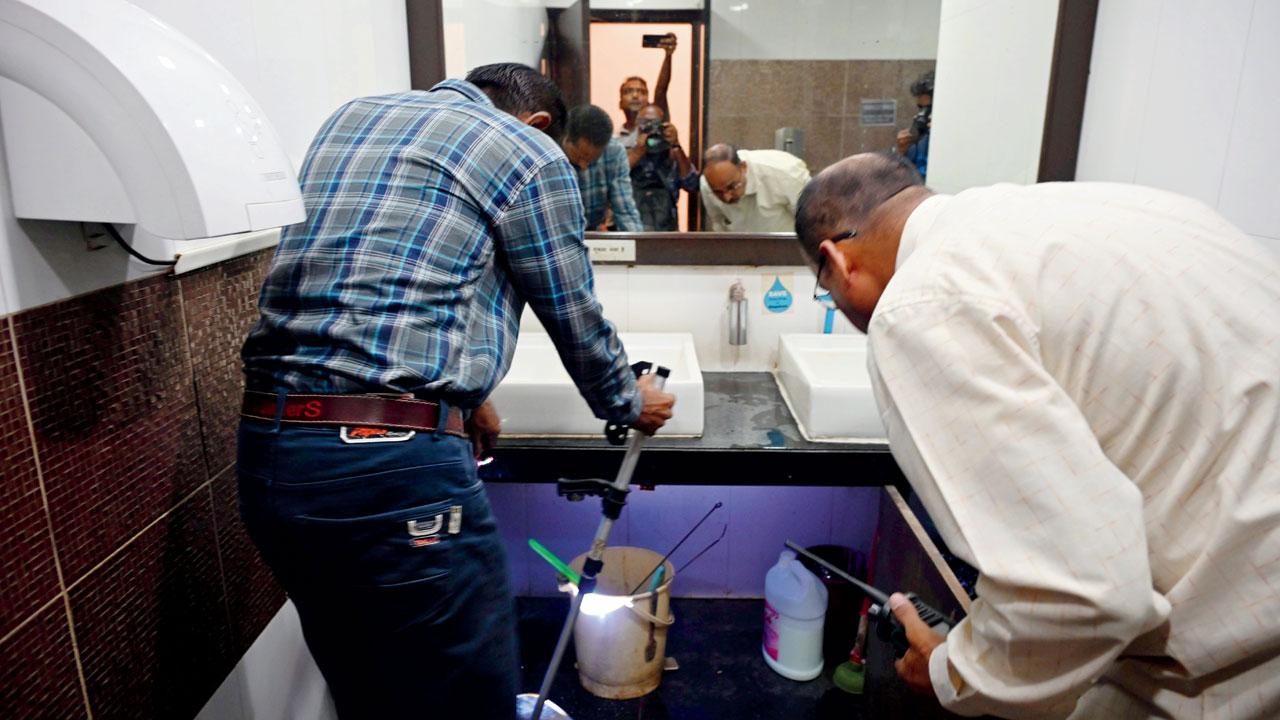 Officials search for the planted ‘gas bomb’ inside the Club premises