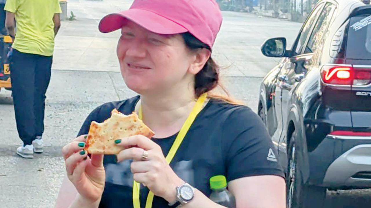 A runner enjoys a slice of pizza.  pic courtesy/The bRUNch Club