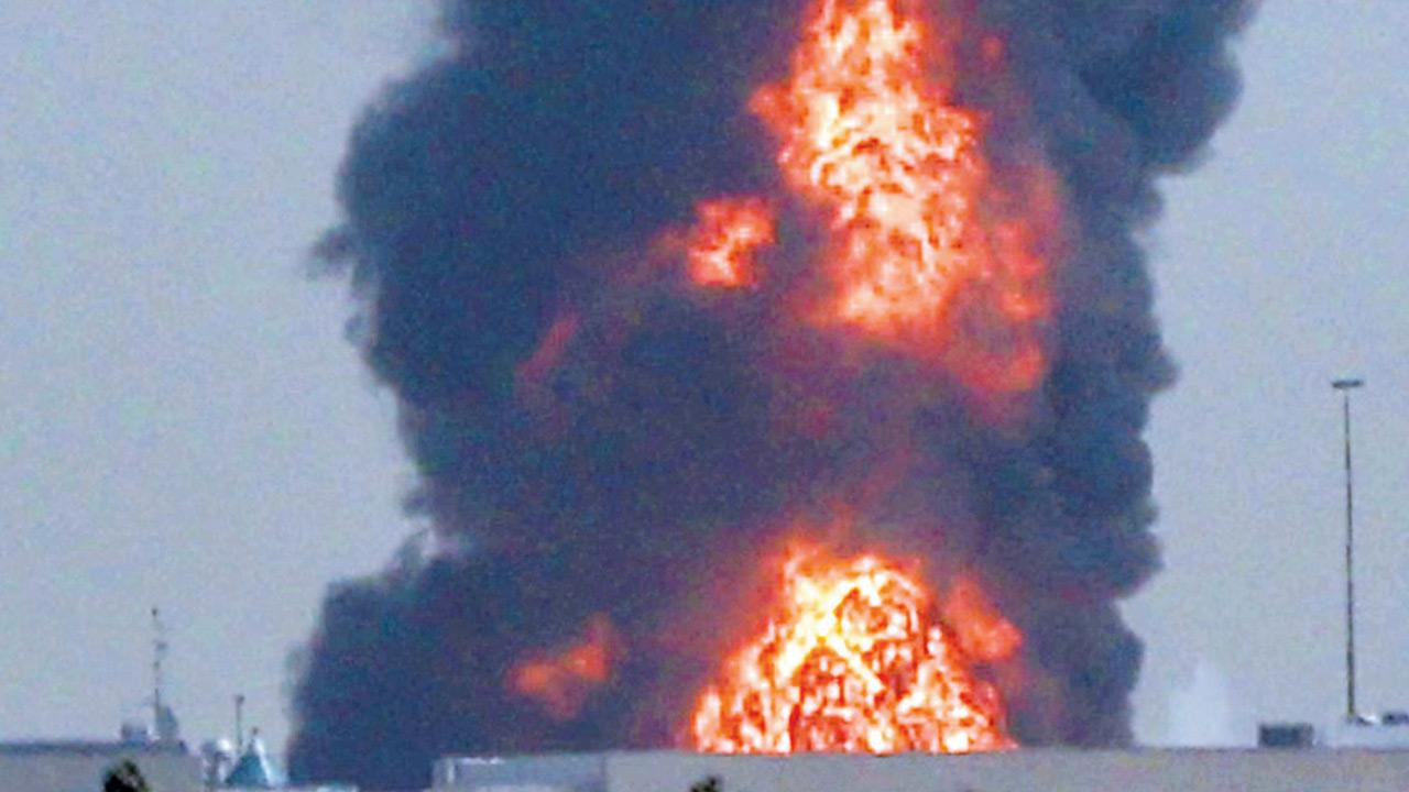 A smoke plume rises from an ongoing fire at Dubai International Airport in Dubai on March 16. PIC/AFP