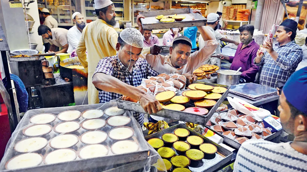 The aroma of traditional sweets and dates fills the air as markets overflow with activity