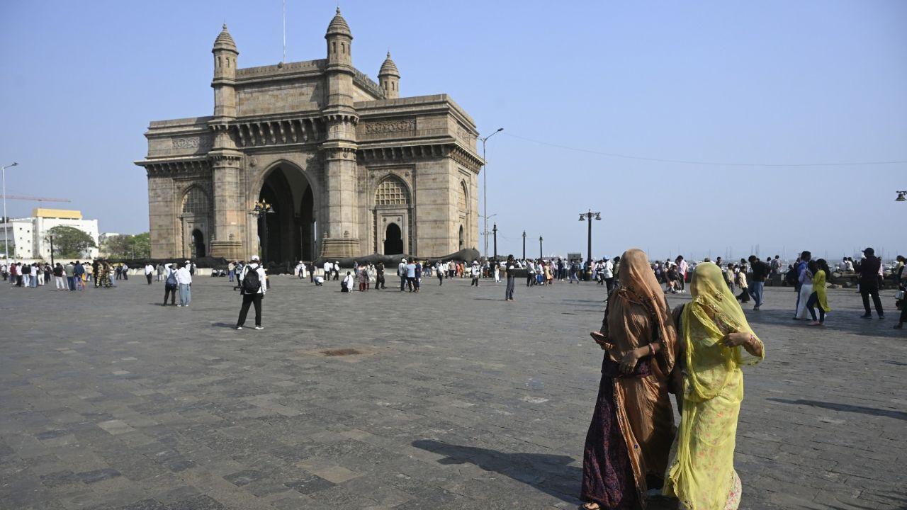 Women cover their heads to protect themselves from the scorching heat at Gateway of India.