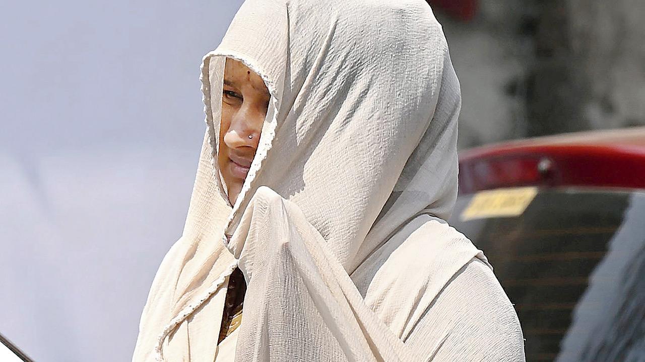 A woman shields her head from the sun with a scarf in Worli. PIC/ASHISH RAJE