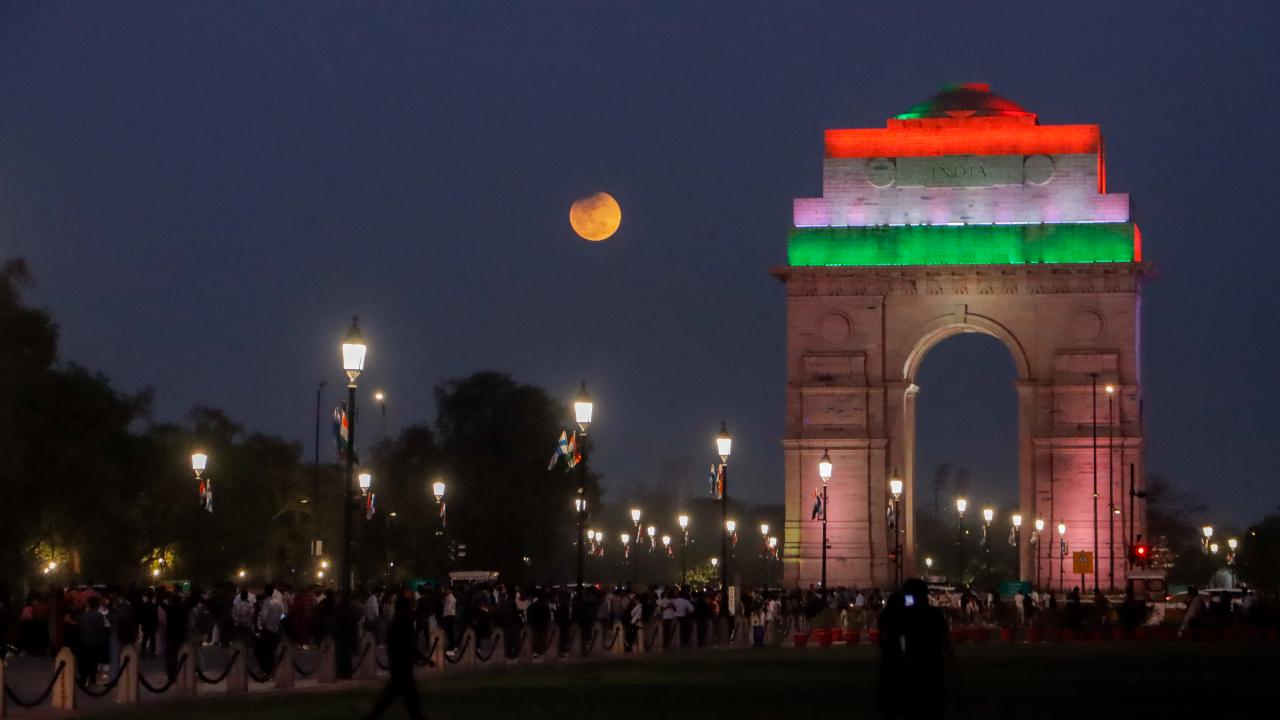 The Lunar Eclipse moon is seen during the lunar eclipse beside India Gate, in New Delhi, Tuesday, March 3