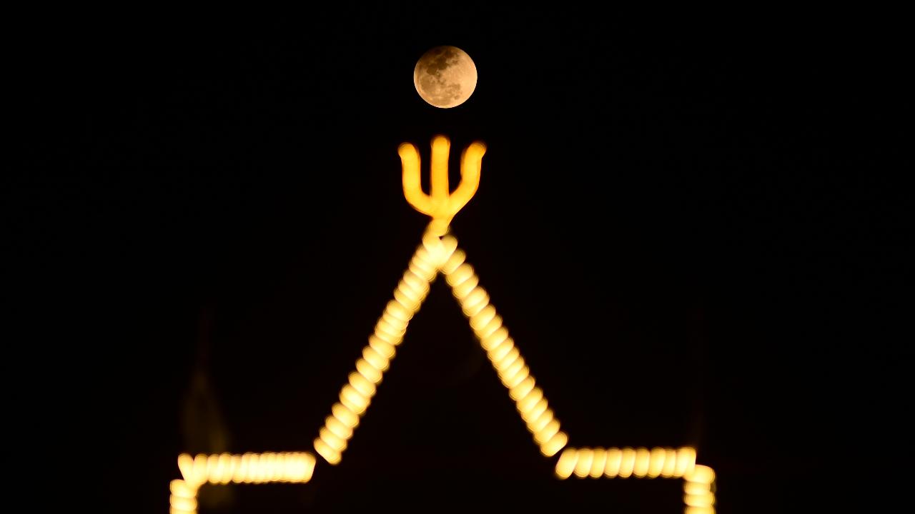 Locals saw a different shade of the moon the night sky due to the lunar eclipse, also called the 'Blood Moon', in Prayagraj in Uttar Pradesh on Tuesday, March 3