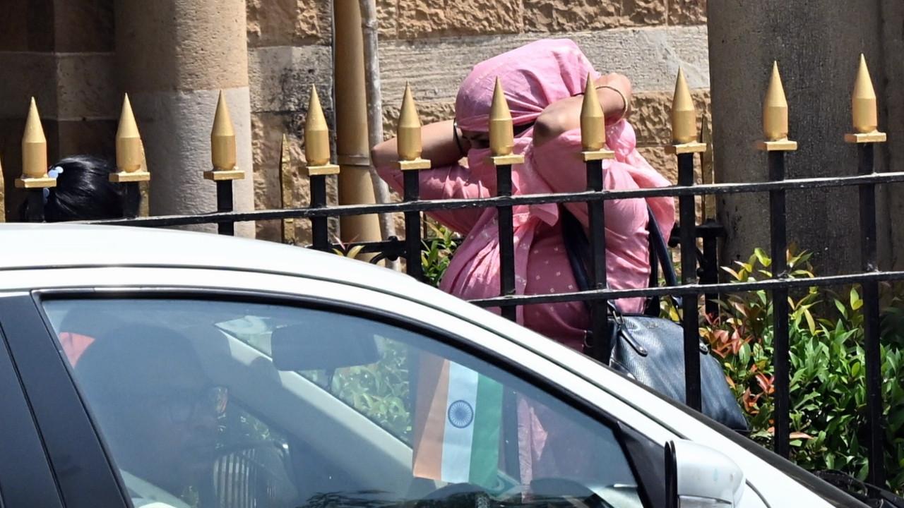 In Photos: Scorching heat grips Mumbai, people cover up to beat sun