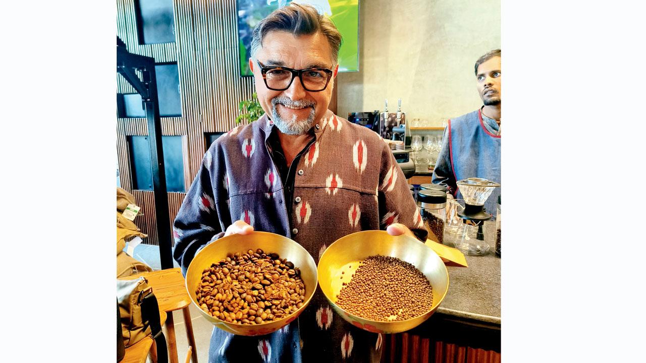 Marc holds up the largest bean in the world, Borneo Liberica, and the smallest bean, Wightiana
