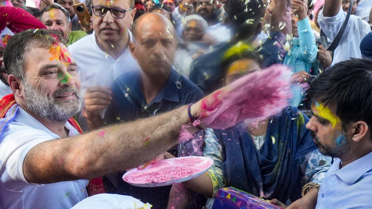 Surrounded by workers, leaders and journalists at the party office, Gandhi applied colours on everyone and was smeared by 'gulal' in return.