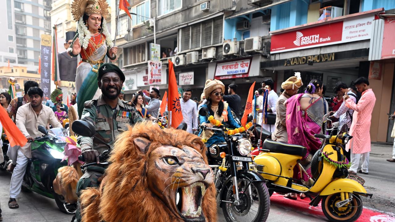 A majestic lion float rides alongside a stunning Goddess idol on a decorated scooter in Mumbai's Gudi Padwa bike procession, symbolising strength, devotion, and vibrant Marathi tradition