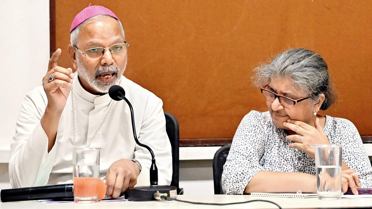 Dominic Savio Fernandes, Auxiliary Bishop (left), speaks during a press conference