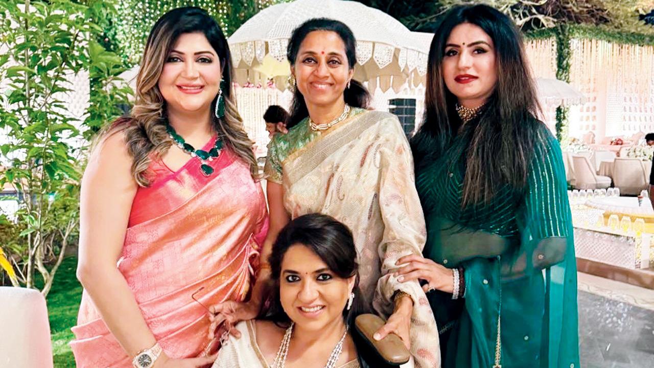 Shaina NC (seated) with Supriya Sule (behind her)