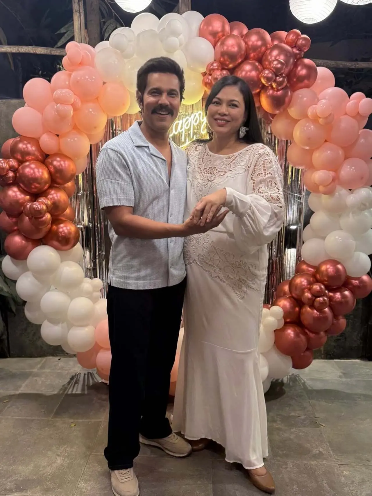 Lin Laishram embraced an elegant maternity style in this look, choosing a flowing white gown that beautifully highlighted her baby bump. The outfit featured delicate lace embroidery and soft, billowy sleeves.
