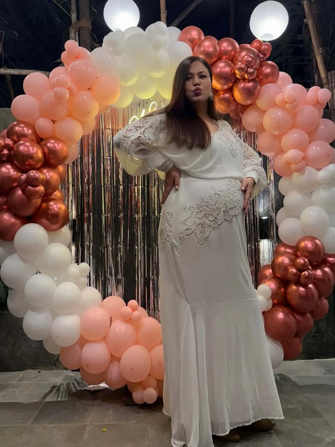She kept her styling minimal with straight, open hair and natural makeup, allowing her pregnancy glow to stand out. Posing confidently in front of a pastel balloon backdrop, Lin looked radiant as she cradled her bump.