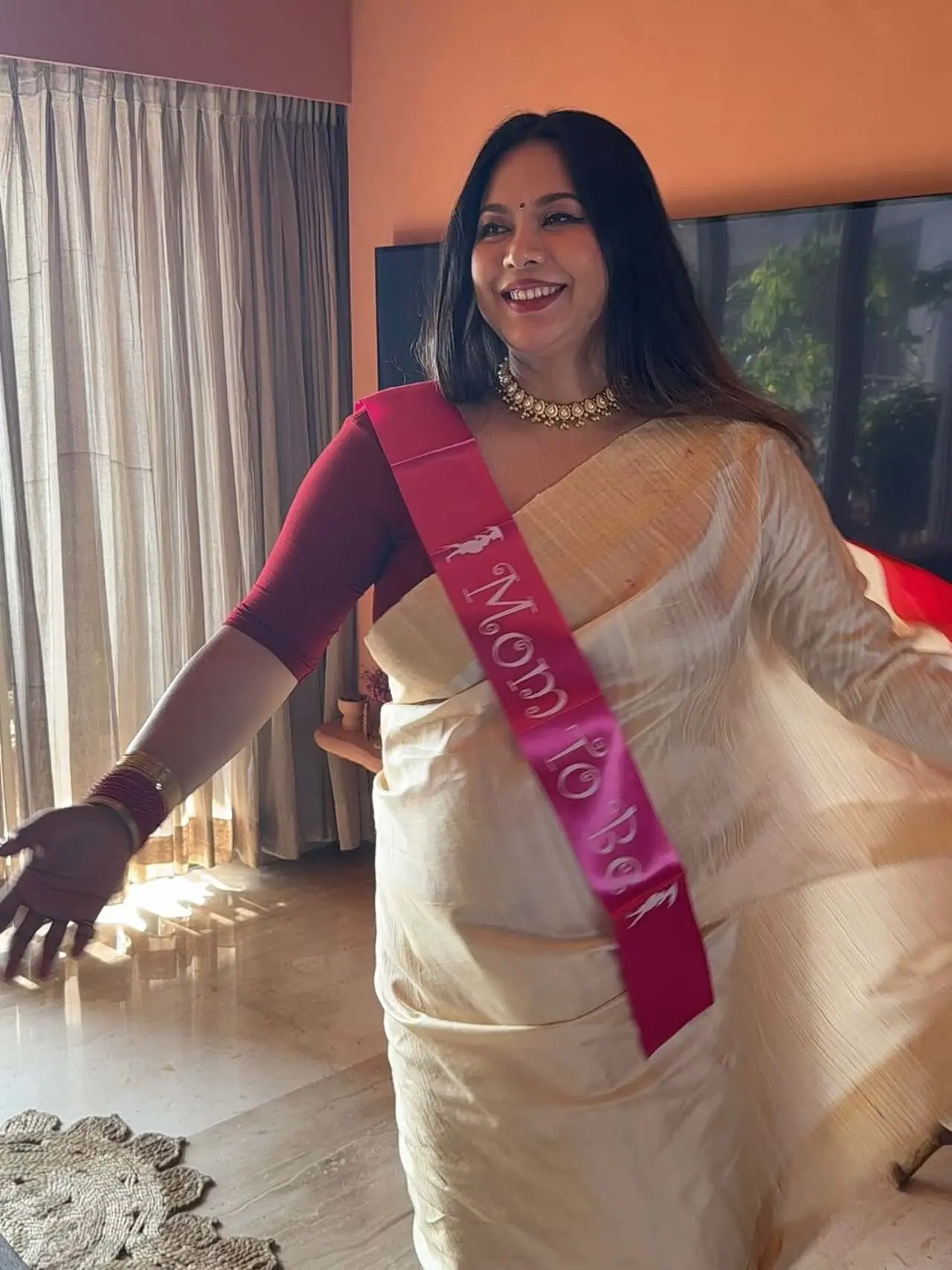 The saree was paired with a matching red blouse and delicately adorned with fresh floral jewellery, including a maang tikka, necklace, bangles, and waist adornment.