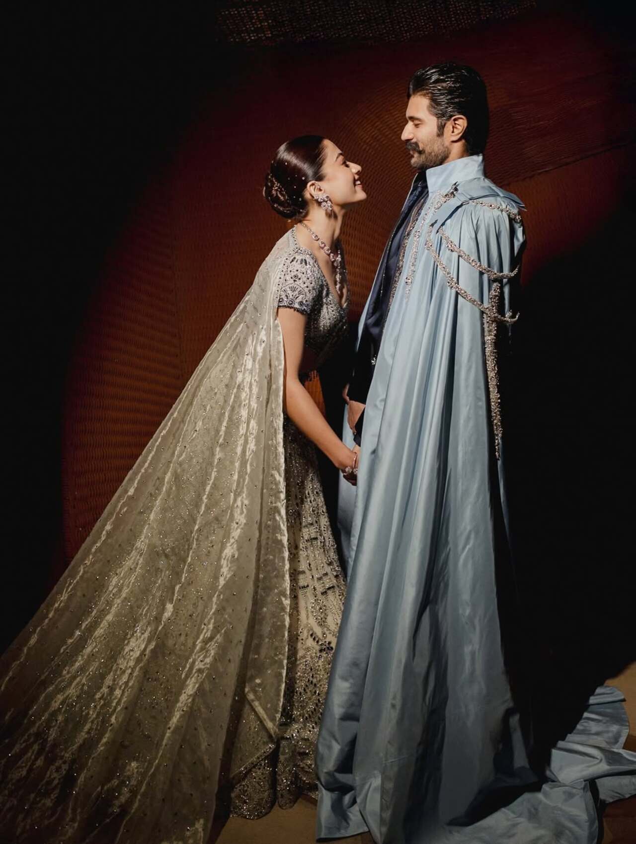 Rashmika looked ethereal in a heavily embellished champagne-gold blingy lehenga, featuring intricate beadwork and detailed embroidery. Her blouse was richly adorned, perfectly complementing the flowing skirt, while a matching dupatta was draped elegantly over her shoulders.