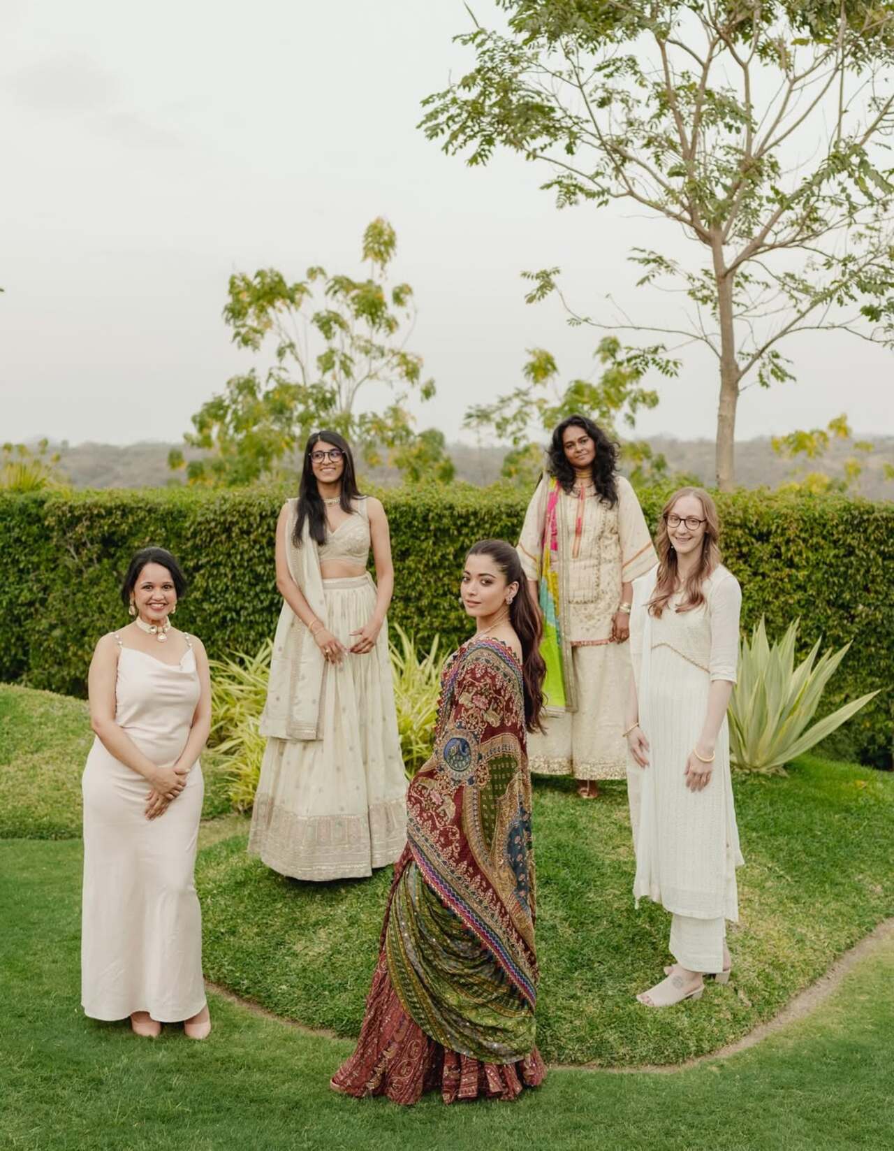 Rashmika Mandanna shared a cheerful moment with her bridesmaids during the wedding festivities, posing happily alongside them.