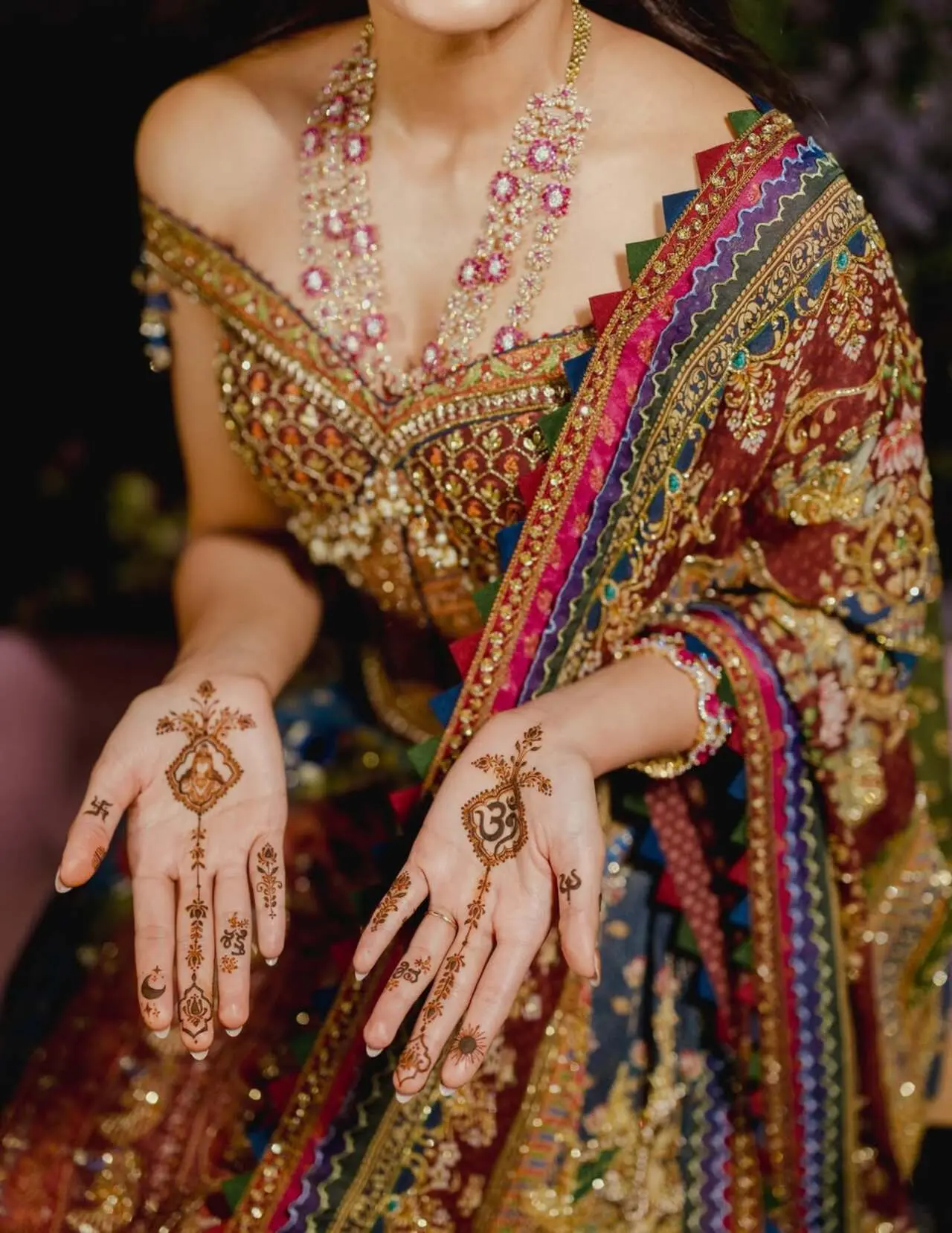 Rashmika opted for a minimal yet meaningful mehendi design rather than heavily filled palms. One of her palms featured the Om symbol. The design also included delicate floral patterns and sacred symbols.