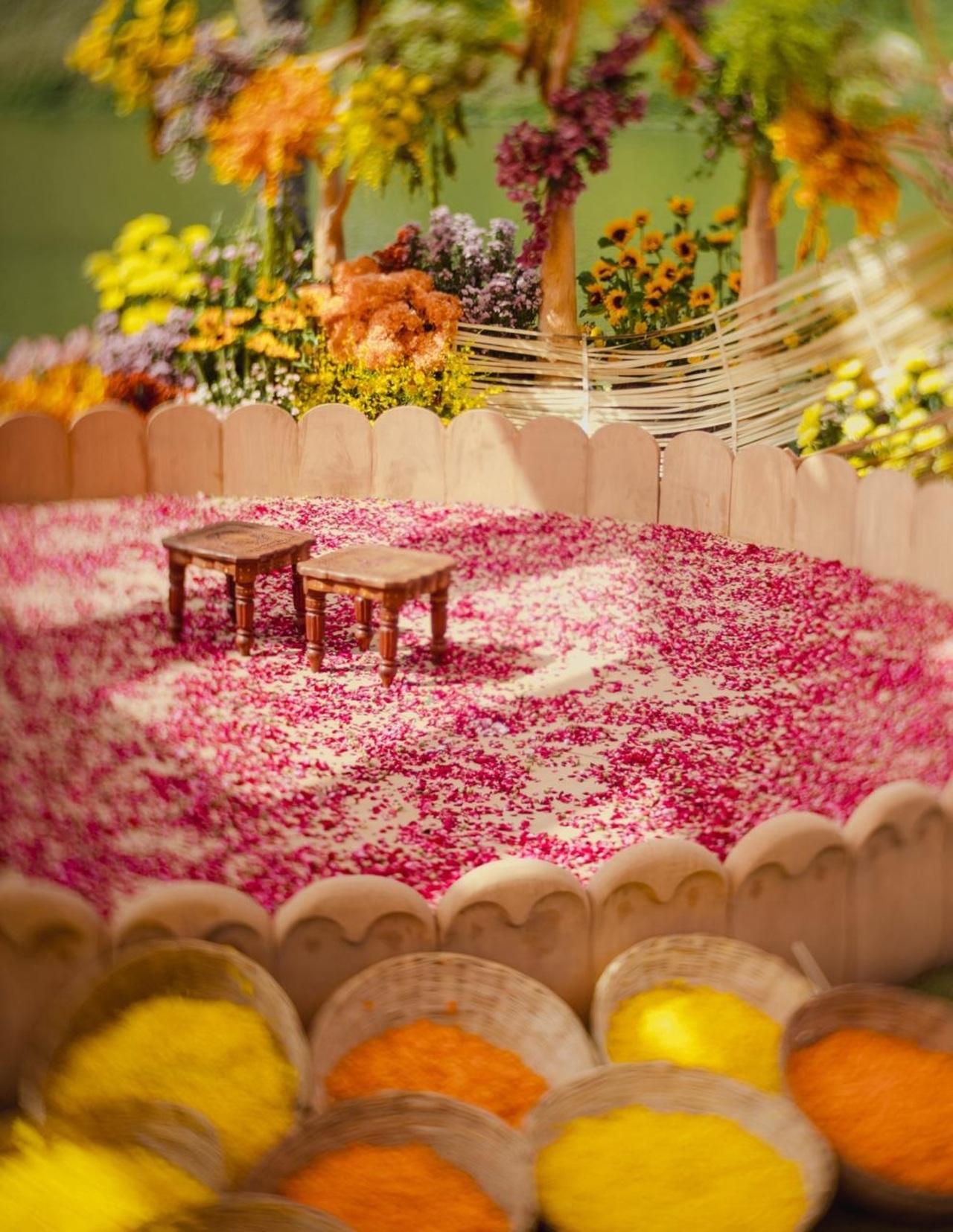 Set against a beautifully styled outdoor backdrop, the decor embraced traditional festive hues with bright marigolds, yellow florals, and elegant wooden elements that created a warm and cheerful atmosphere.