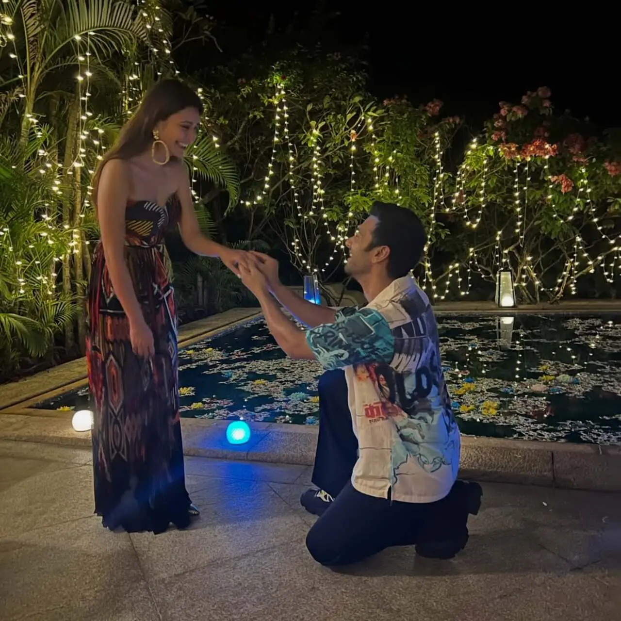 Pulkit goes down on one knee, putting a ring of her finger. 