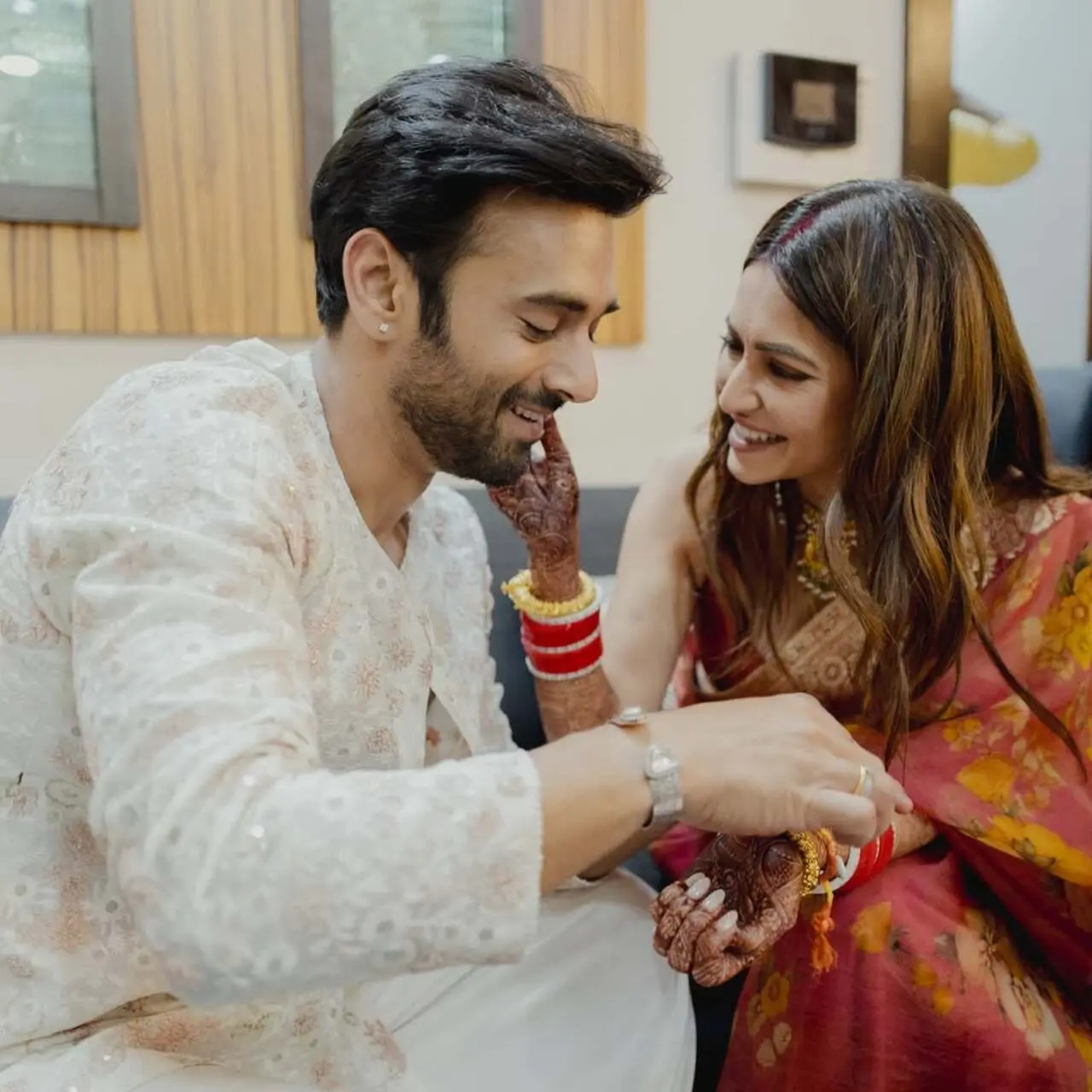 In the last still, Kriti was adorably pulling hubby Pulkit's cheeks simply because 