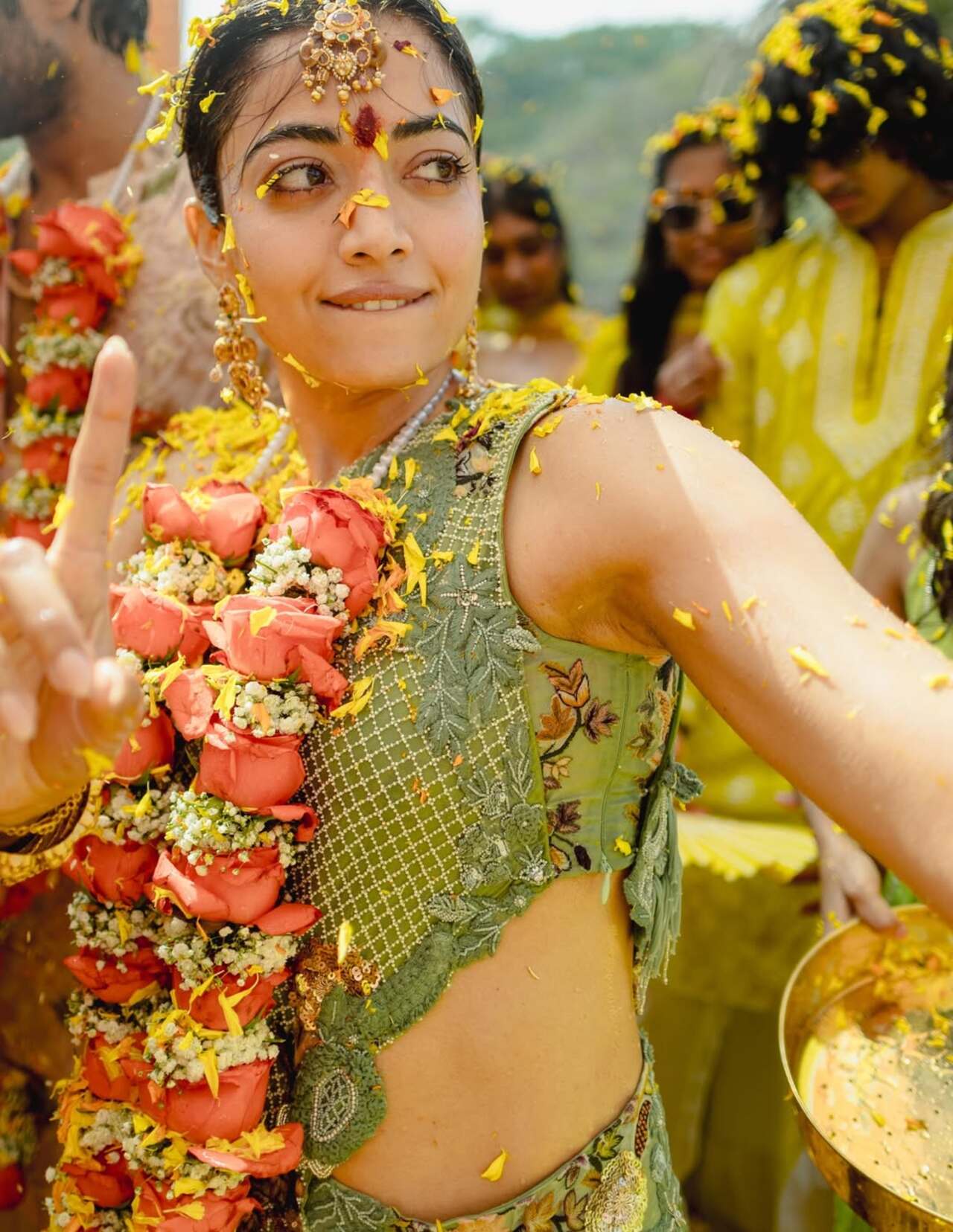 Rashmika Mandanna looked radiant as she danced joyfully during her Haldi ceremony, drenched in a shower of bright yellow flower petals. Surrounded by loved ones, the bride-to-be embraced the festive spirit.