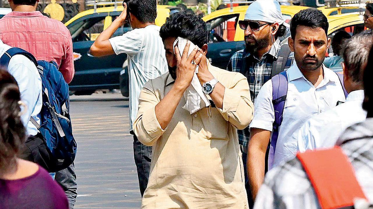 A man wipes the sweat from his face