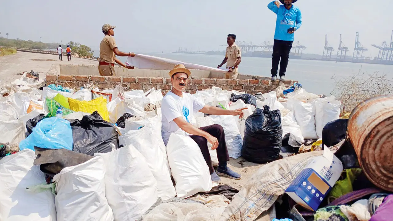 Nandakumar Pawar with the waste collected from Elephanta Island