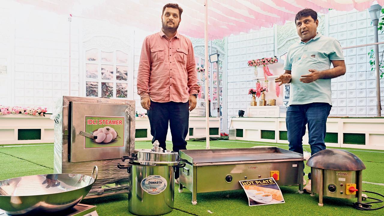 Pankaj Kotecha (right) and nephew Raj Kotecha display their induction cooking setup at Sethia Banquets in Kandivli (West) as caterers adapt to the LPG crisis. Pic/Satej Shinde