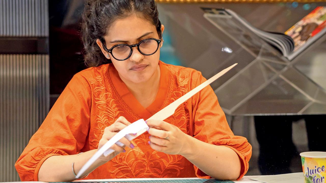An attendee at a previous workshop assembles the pieces of her chuck glider