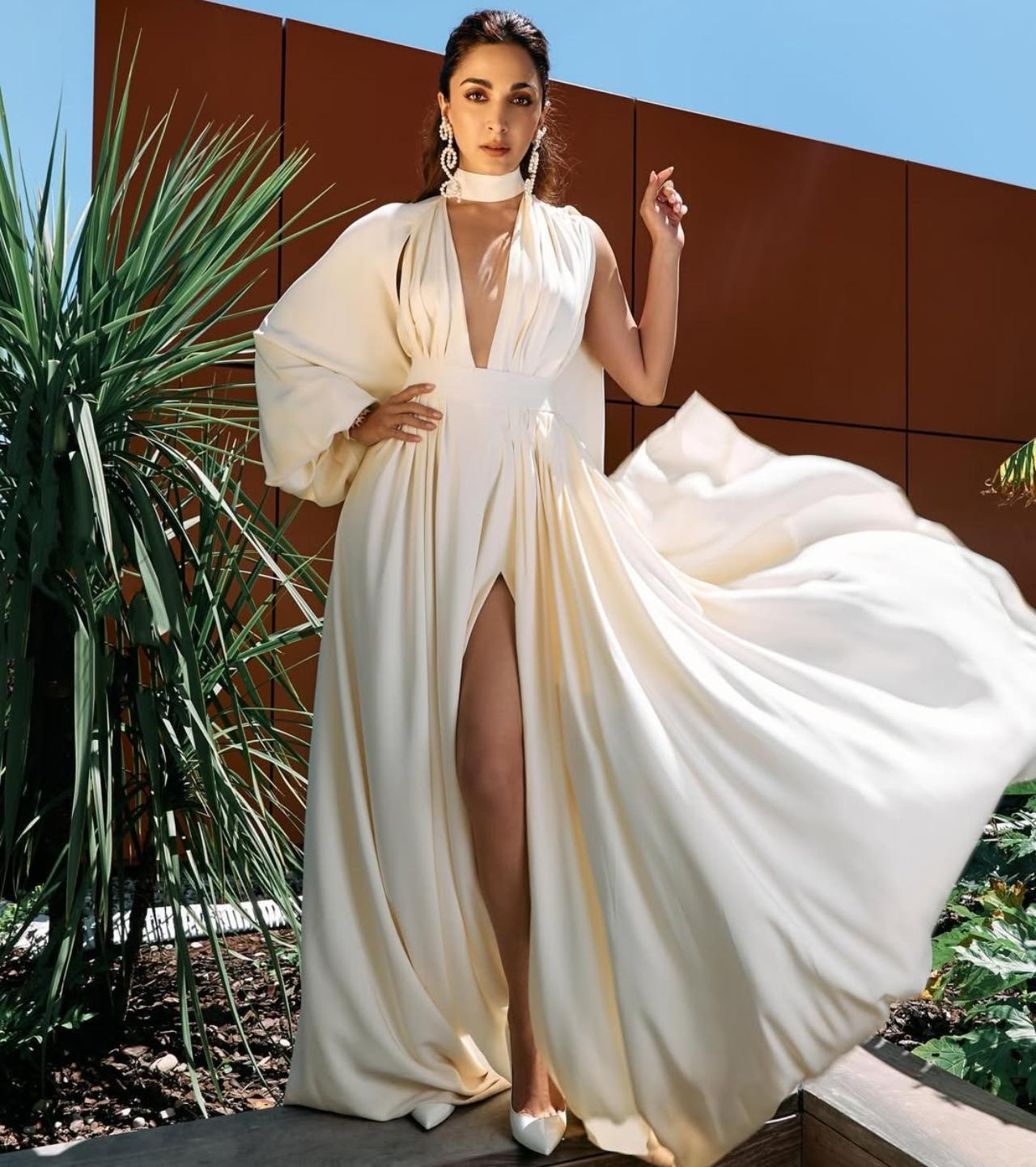 Nothing says statement glam like a slit-detail long dress and Kiara Advani absolutely owns the look. Her all-white gown with a bold slit adds drama and movement, making it ideal for a stylish Holi brunch or an upscale festive gathering. 