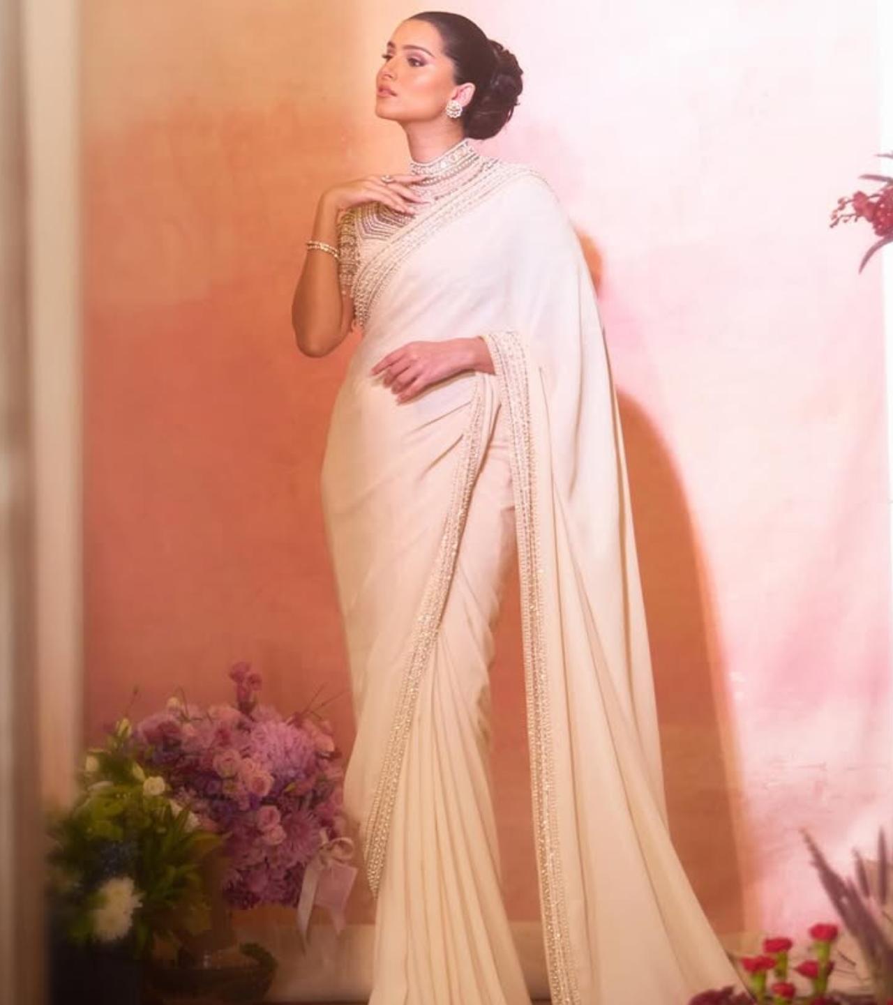 Tara Sutaria stuns in a dreamy all-white saree that feels timeless yet glamorous. The fluid drape paired with soft waves and minimal jewellery creates a refined festive look that works beautifully for daytime celebrations and intimate evening gatherings alike.