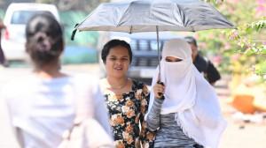IN PHOTOS: Mumbaikars shield themselves from scorching heat