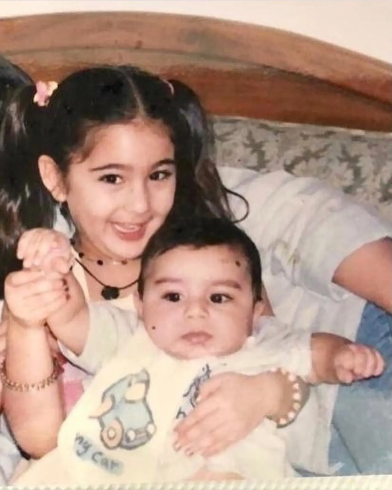 Sara Ali Khan enjoys playtime and strikes a pose with her little brother, who looks as cute as a button, in this picture.