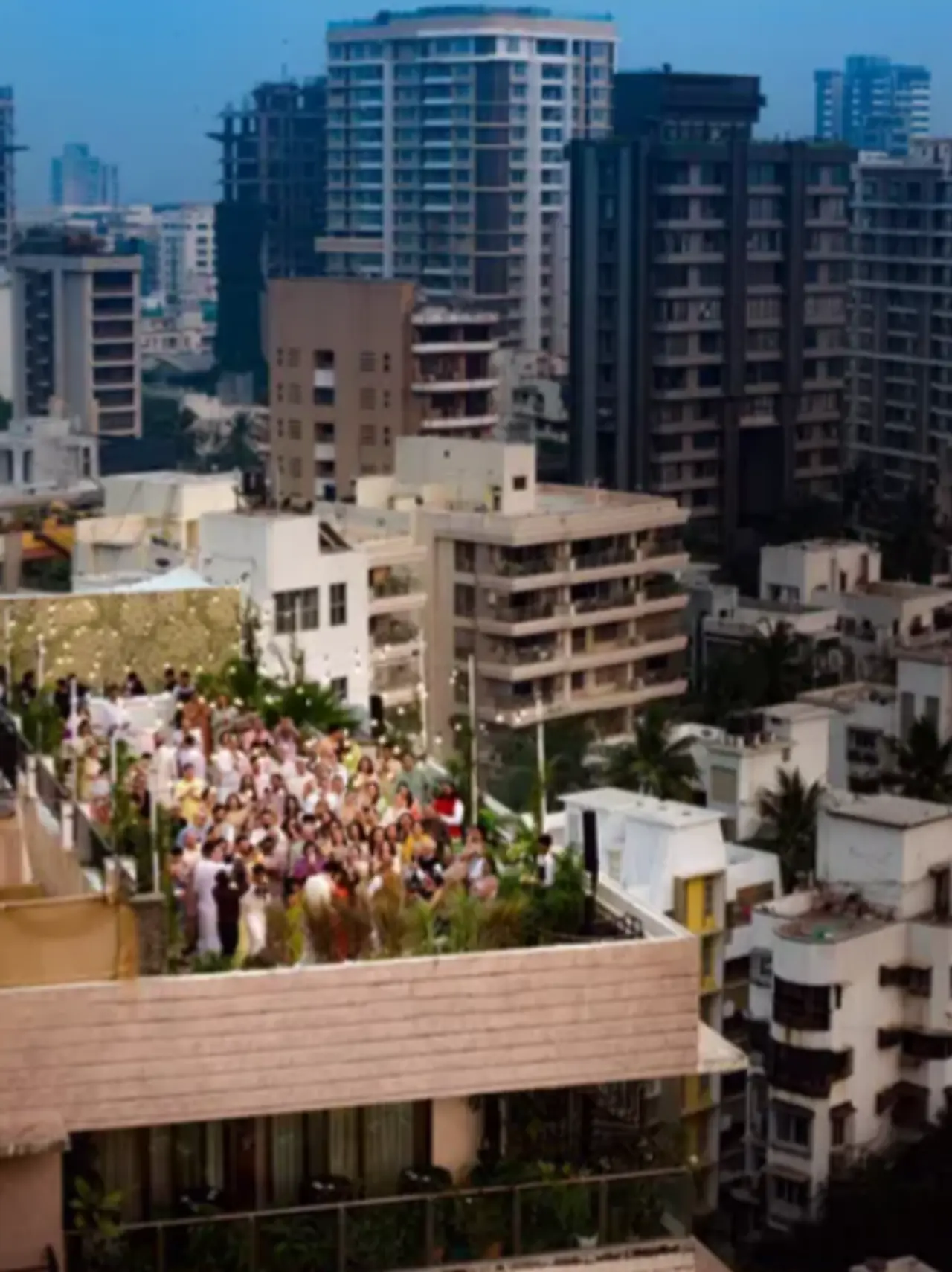 An aerial view of the celebration shows the guests erupt in cheers as the couple shares their first kiss on thier terrace.