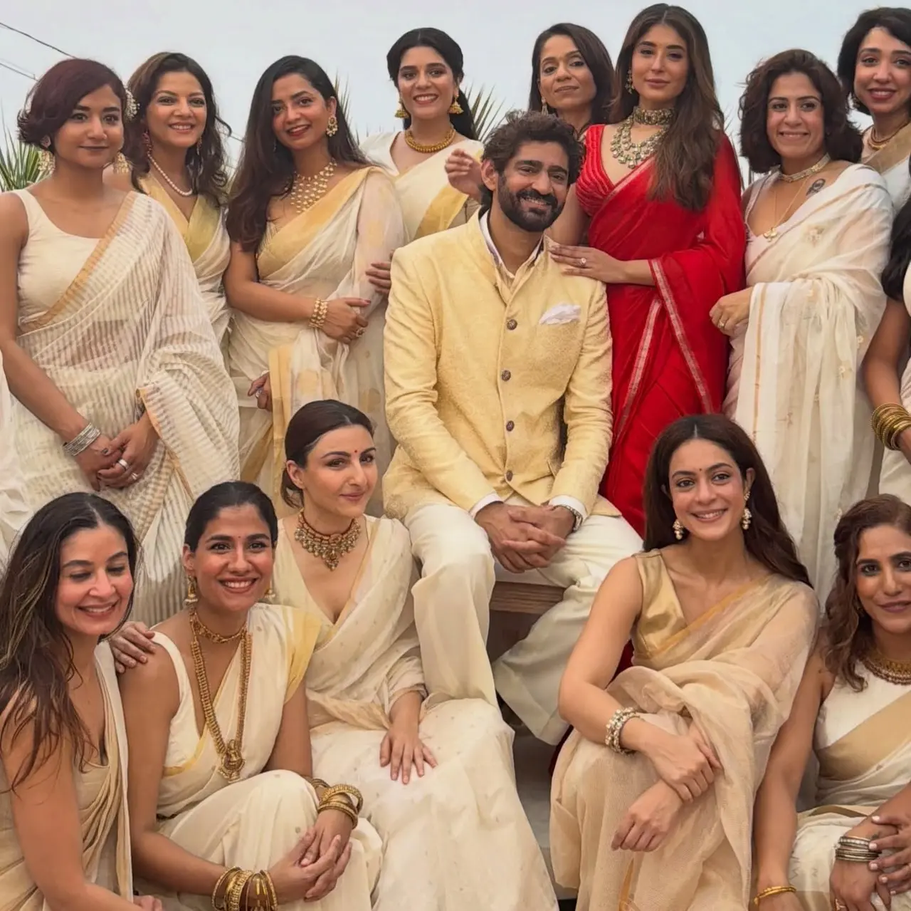 All of Kritika's girlfriends twinned in white, and gold sarees while the bride stood out in her red ensemble.