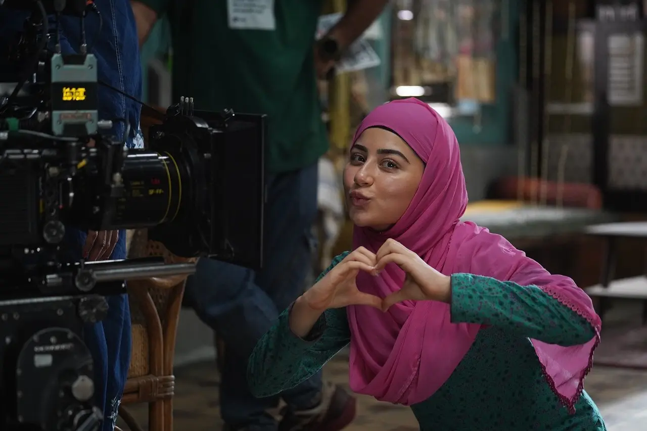 Aditi strikes a pose making a heart with her hand and pouting in the middle of the shoot.