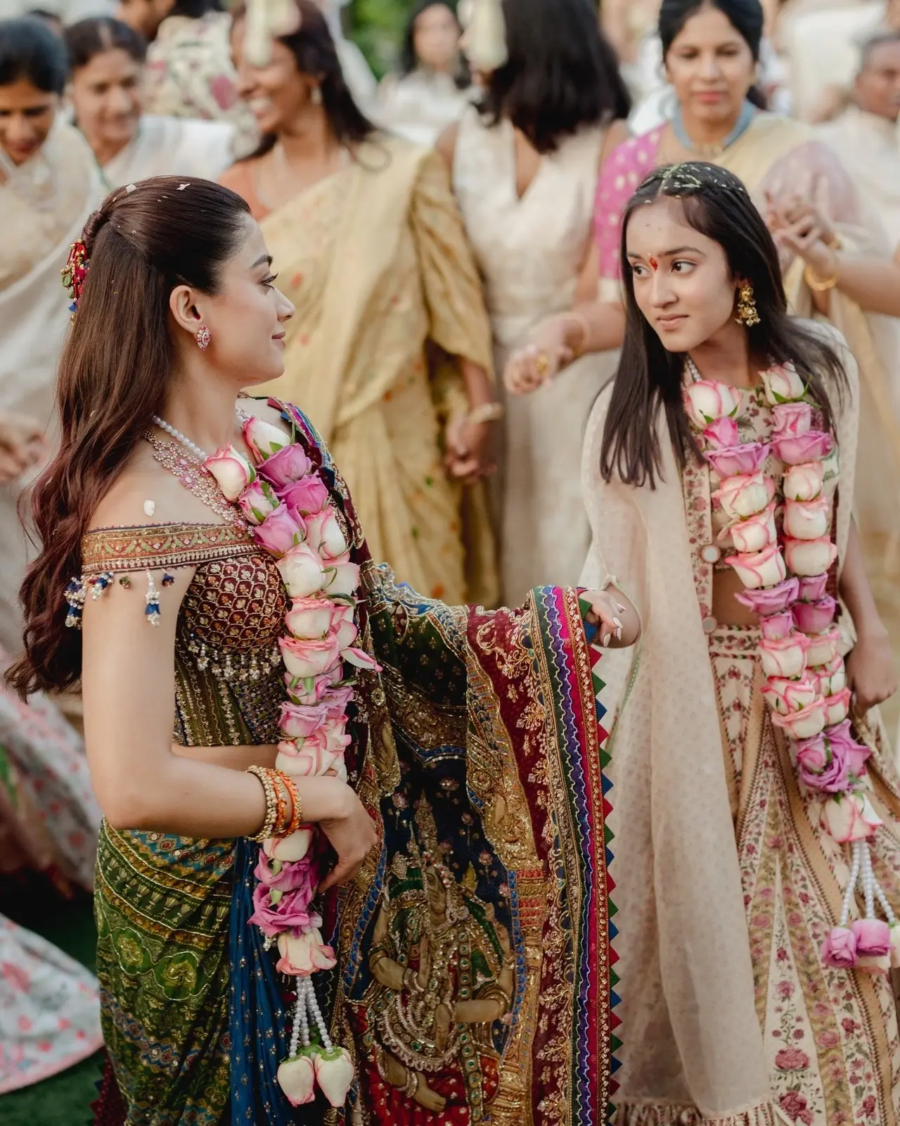 Rashmika and her sister Shiman Mandanna share a candid moment in this adorable picture from the Pradhanam ceremony.